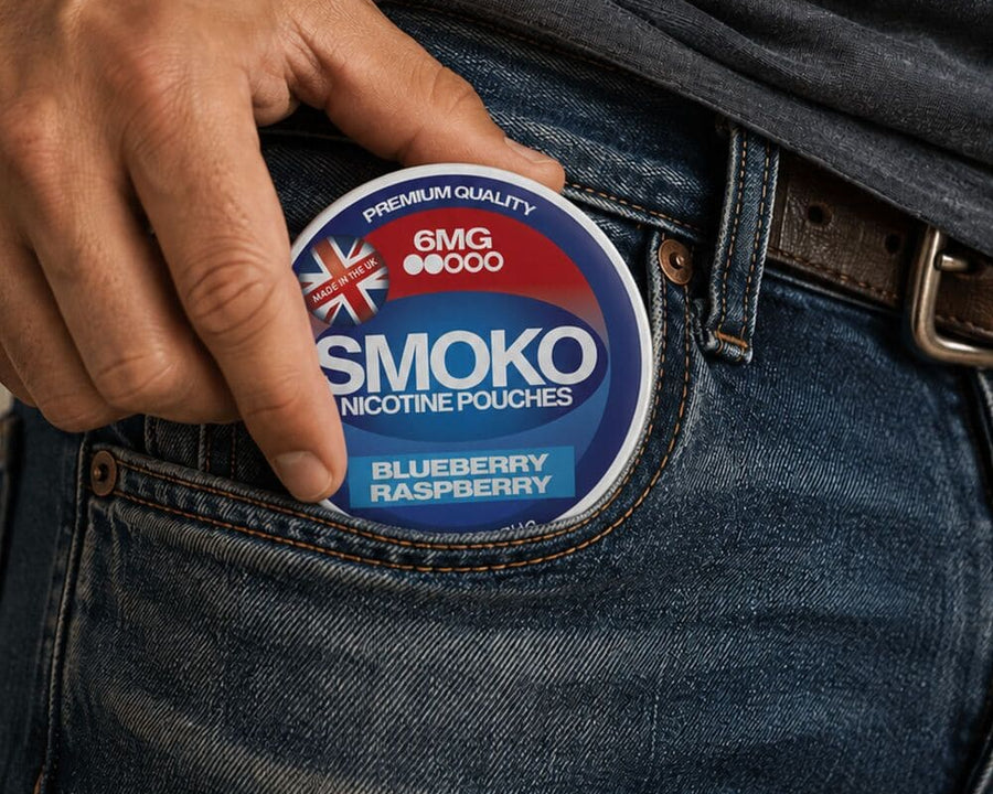 Man putting a can of SMOKO Nicotine Pouches 6MG Blueberry Raspberry in his front pocket