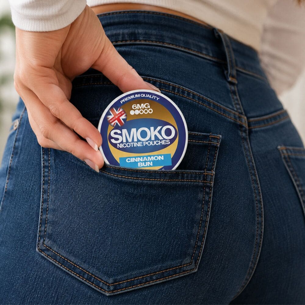 Woman putting a can of SMOKO Nicotine Pouches into her back pocket - Made in the UK